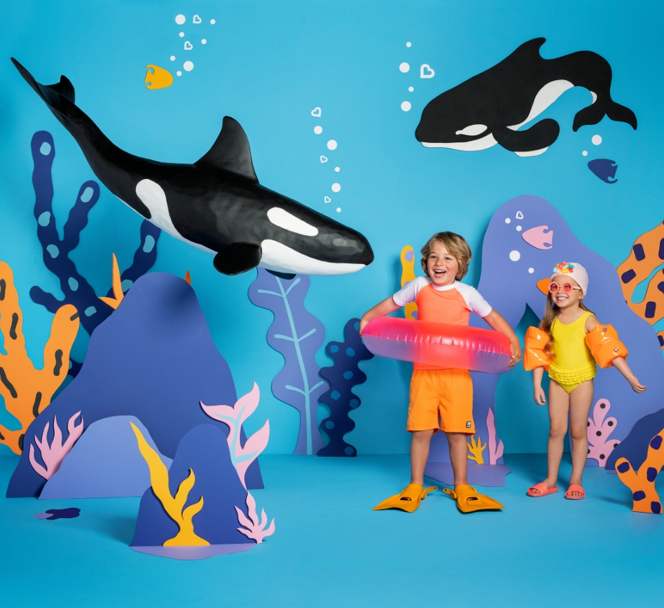 Kids Playing with Orca in Ocean Cover Image