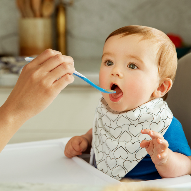Baby Eating from Munchkin Spoon